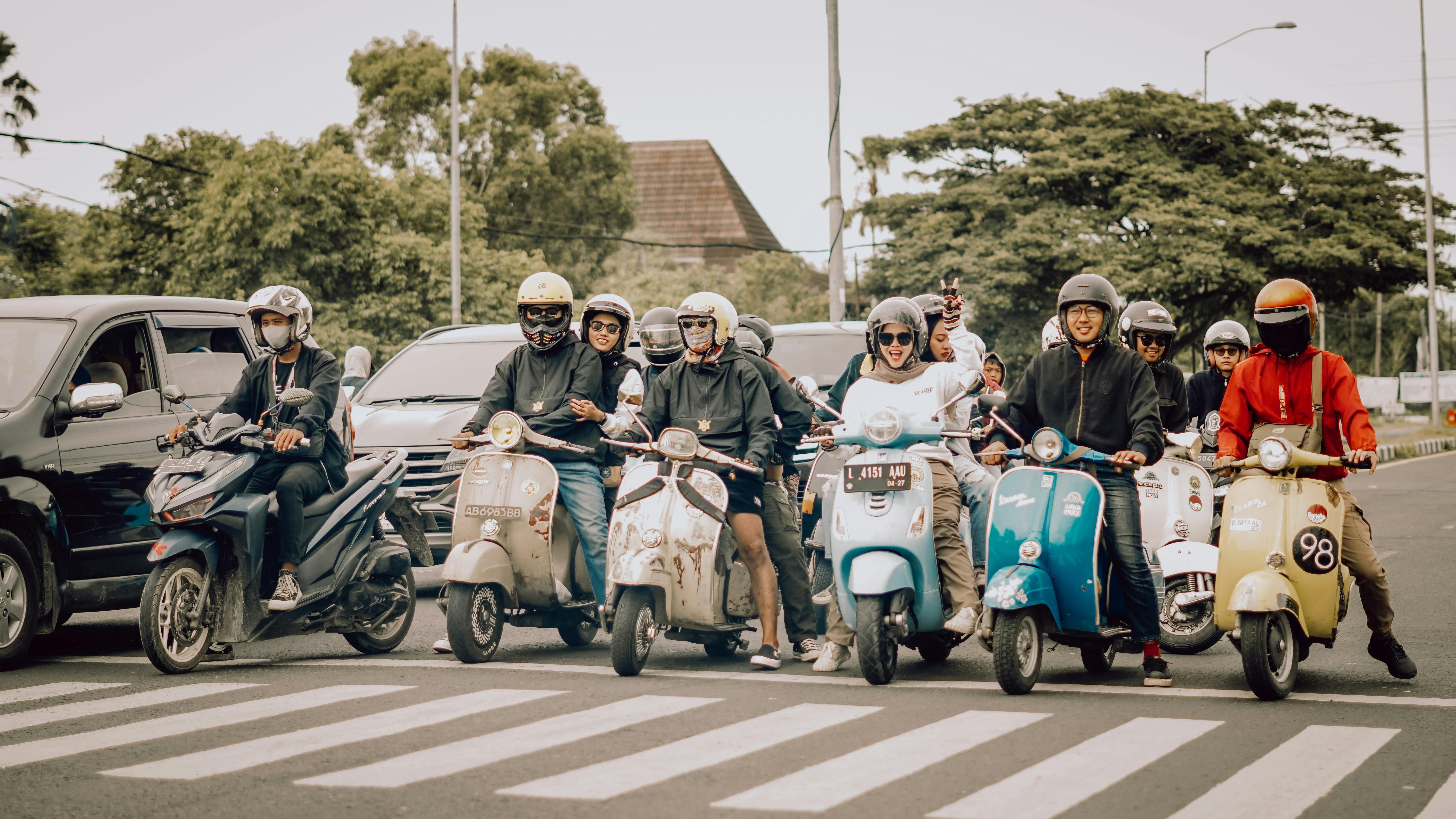 Bali — A lively group of scooter riders waiting at a crosswalk in East Java, Indonesia.