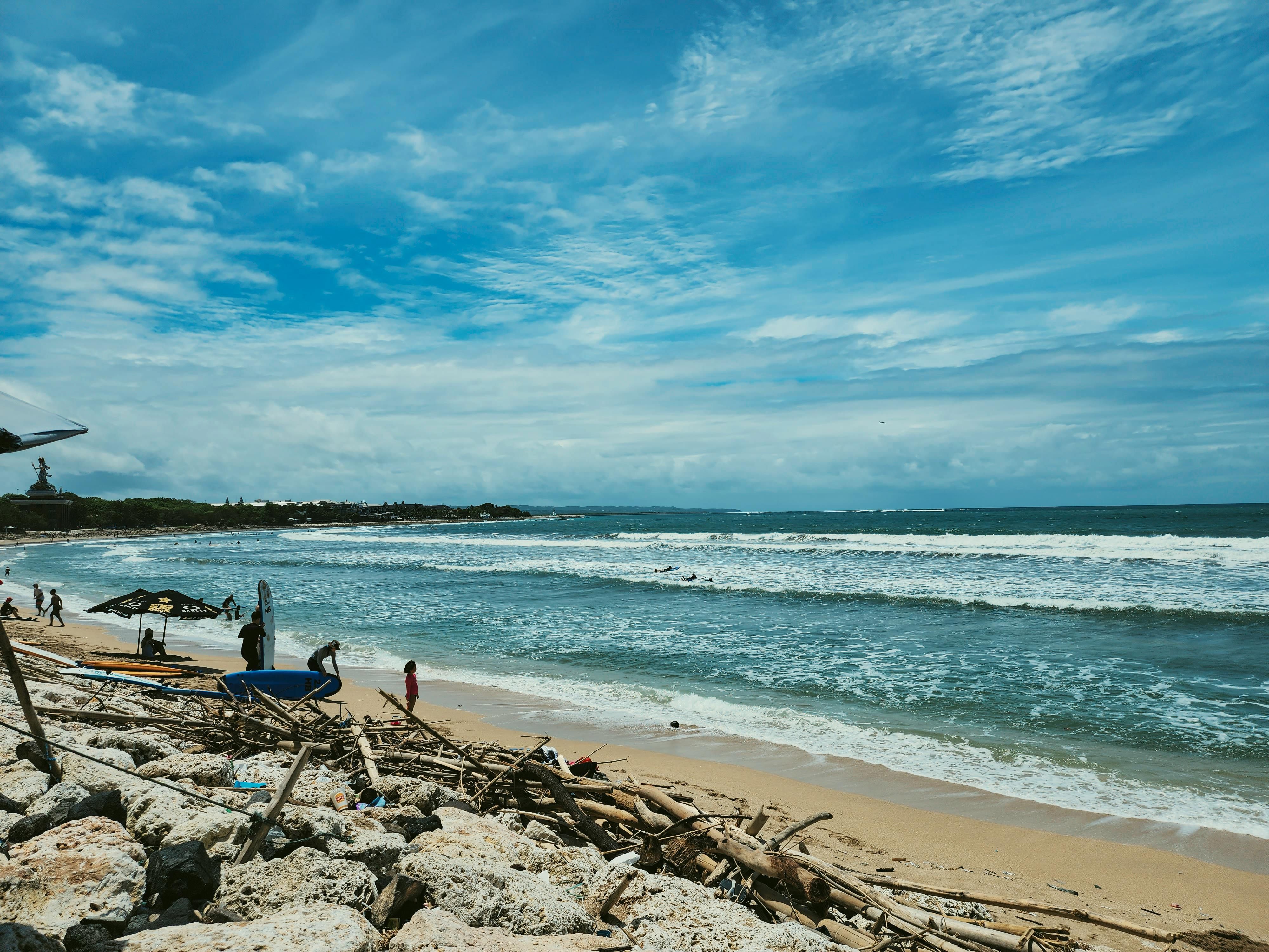 Bali — Peaceful beach scene with waves and blue sky, perfect for relaxation and travel inspiration.