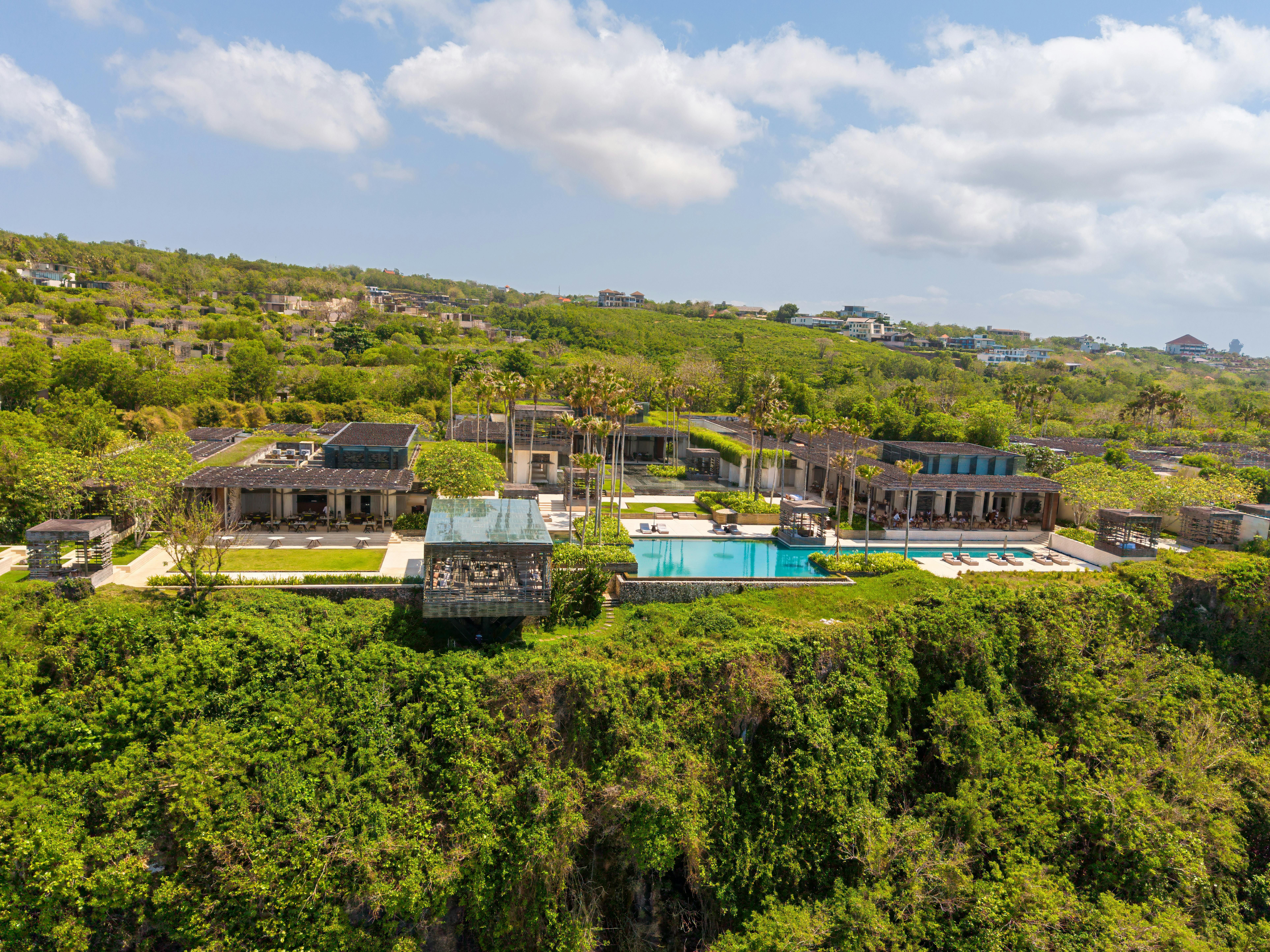 Bali — Aerial view of a luxurious villa with an infinity pool on a cliffside in Bali, Indonesia.