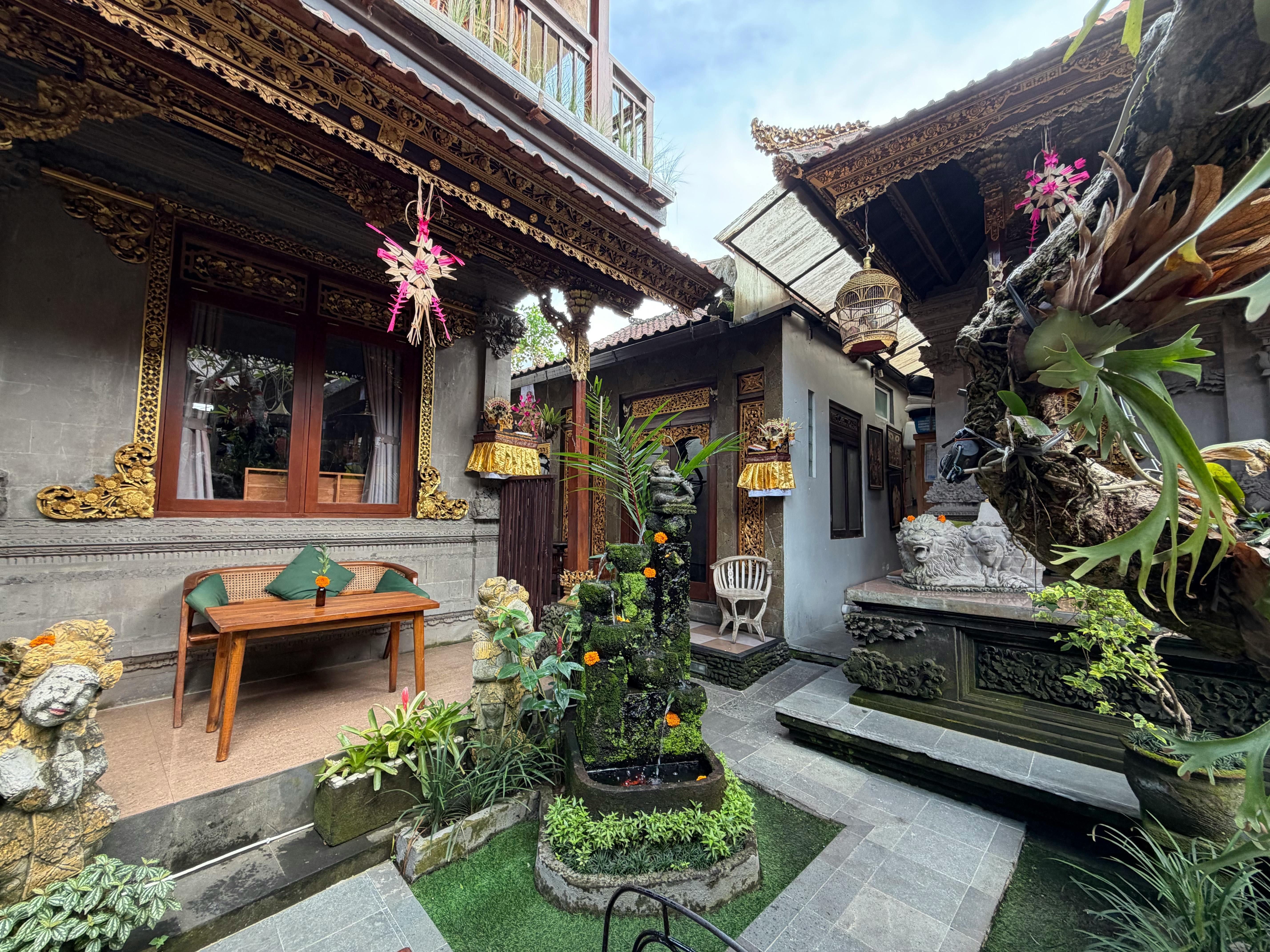 Bali — Charming Balinese courtyard showcasing intricate carvings, lush greenery, and cultural decor.