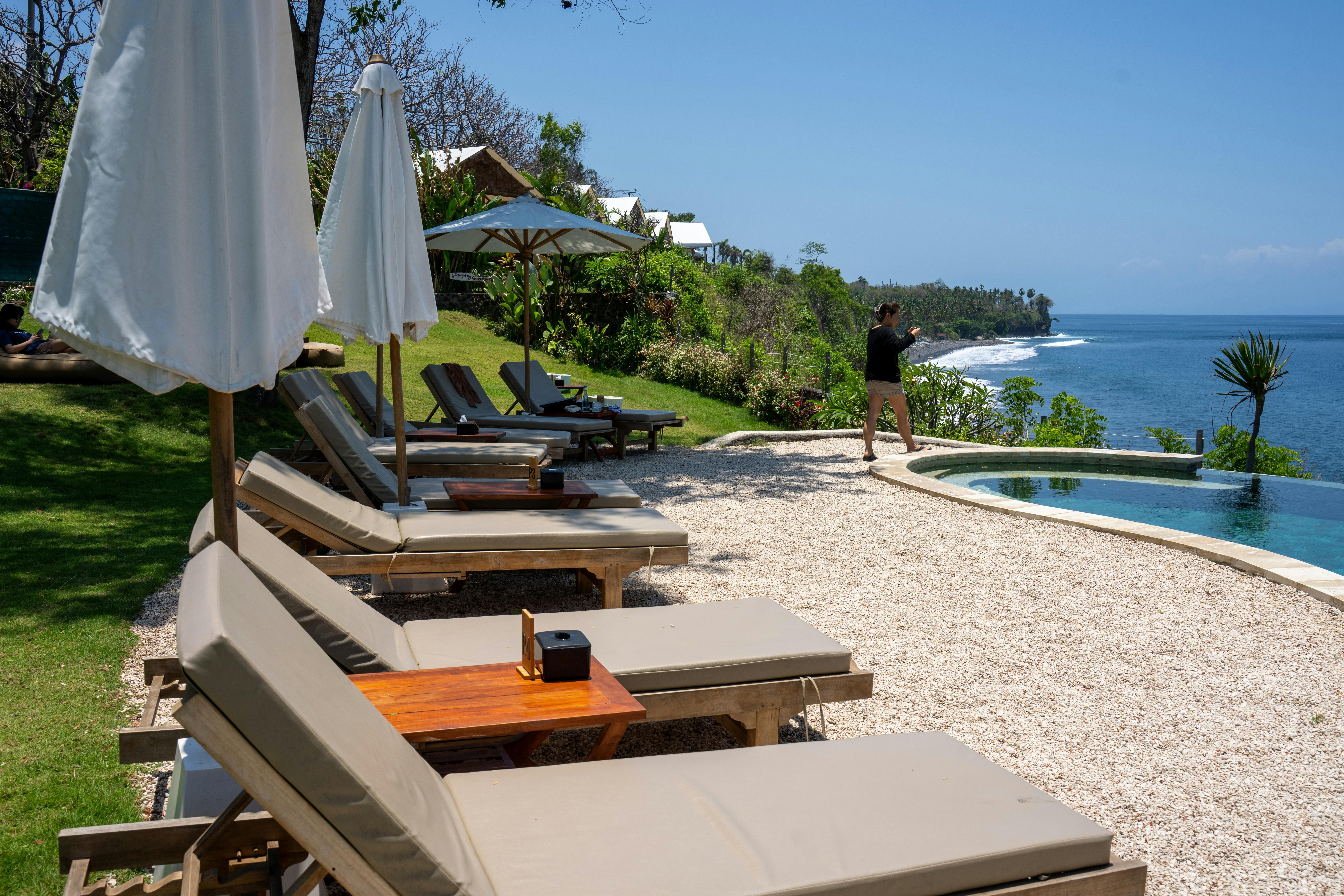 Bali — Relax by the pool with stunning ocean views at a Bali resort.