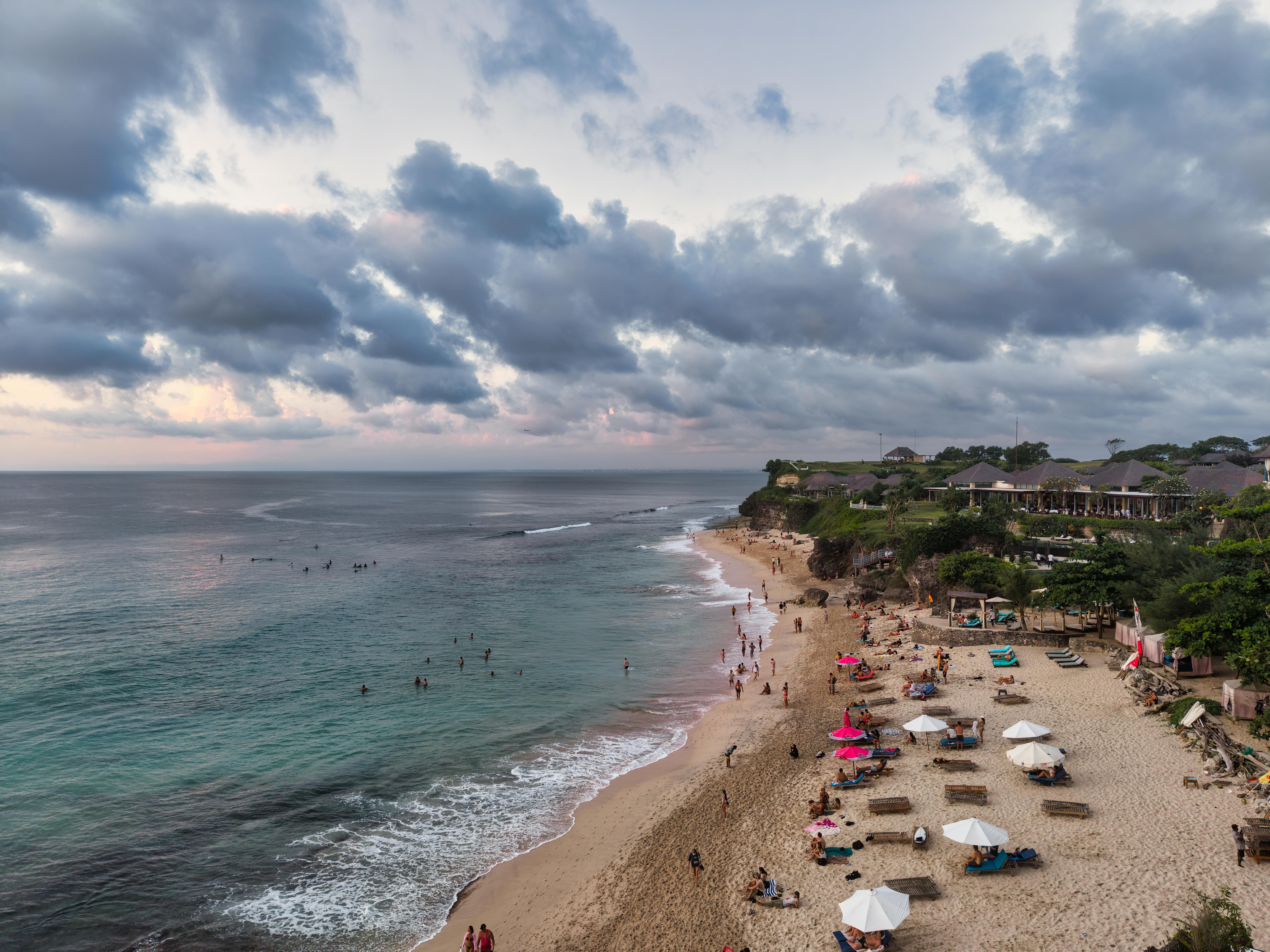 Bali — Stunning aerial view of a beach in Bali, Indonesia with visitors at sunset.