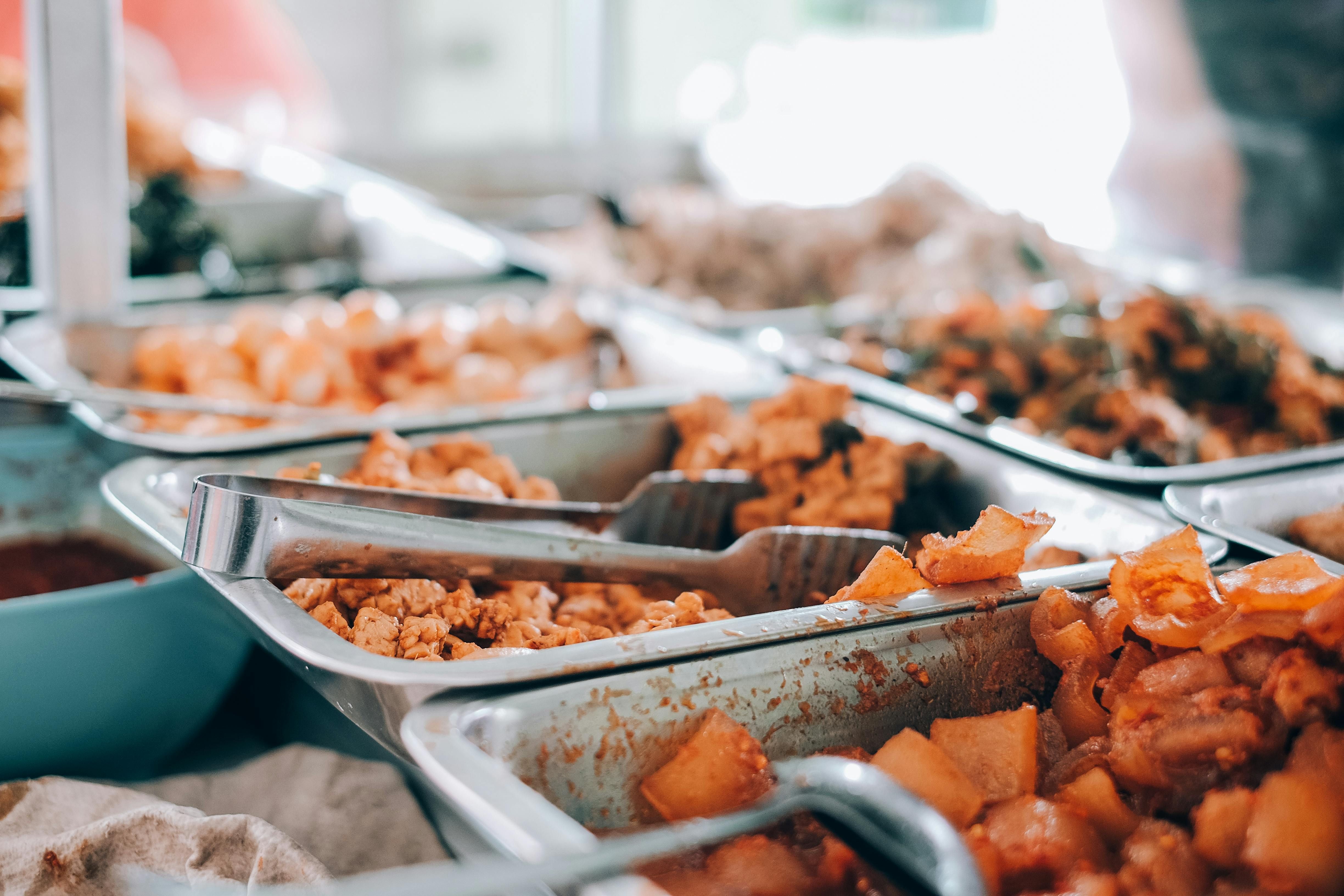 Bali — An inviting display of various hot buffet dishes in stainless steel trays, perfect for food enthusiasts.