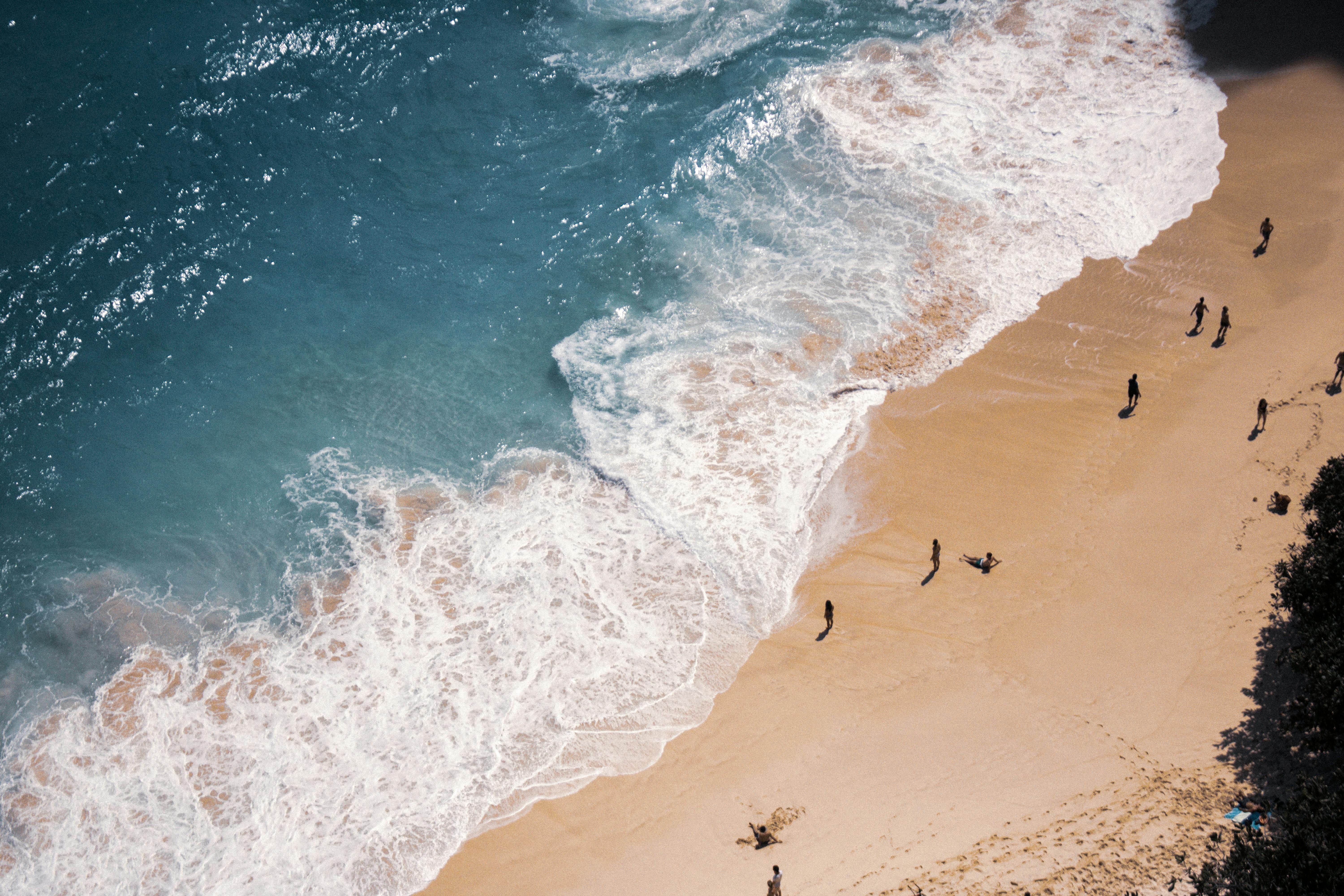 Bali — A stunning aerial view of a Bali beach with turquoise waters and crashing waves, capturing a serene coastal vibe.