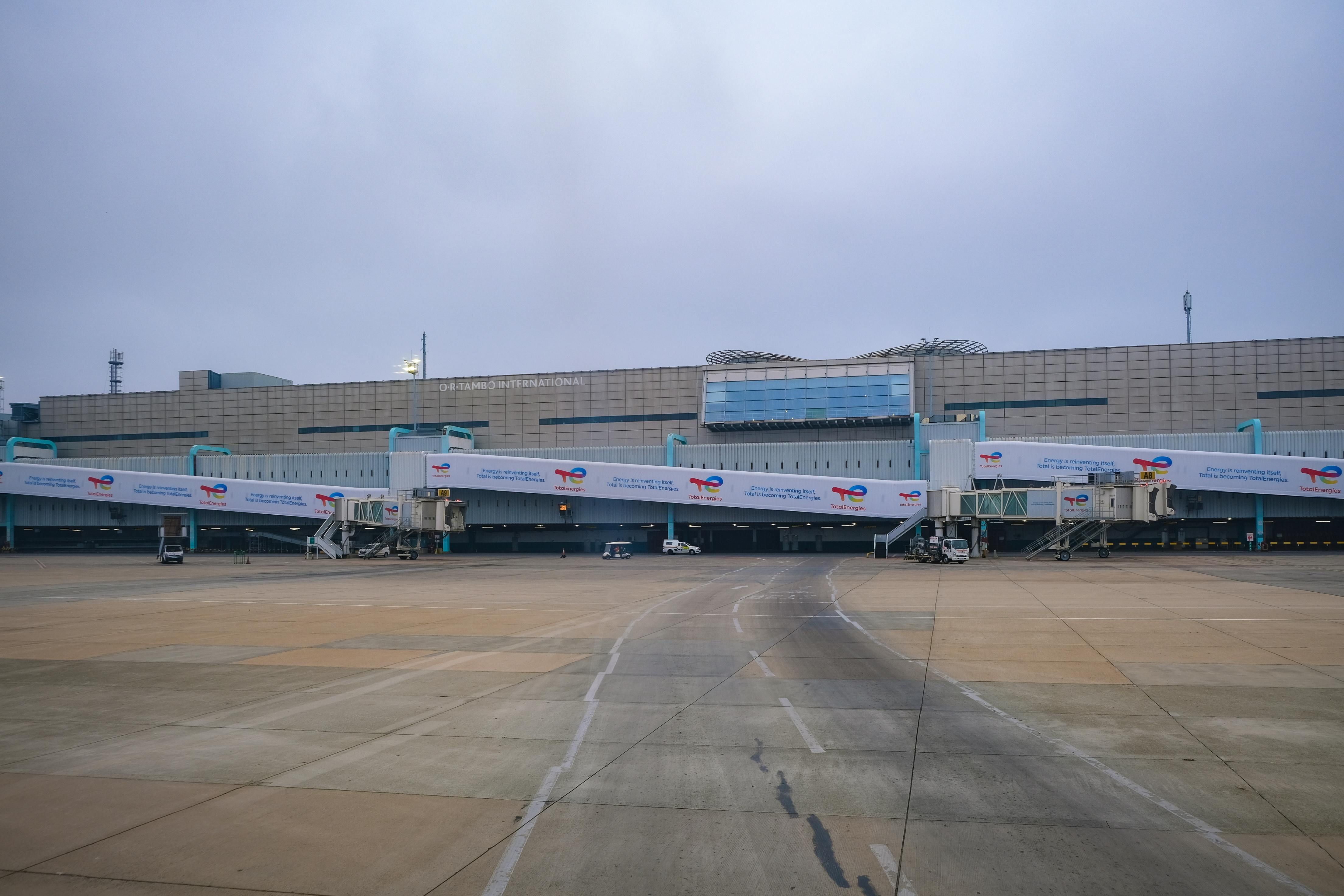 Bali — View of a modern airport terminal with jet bridges leading to the runway.