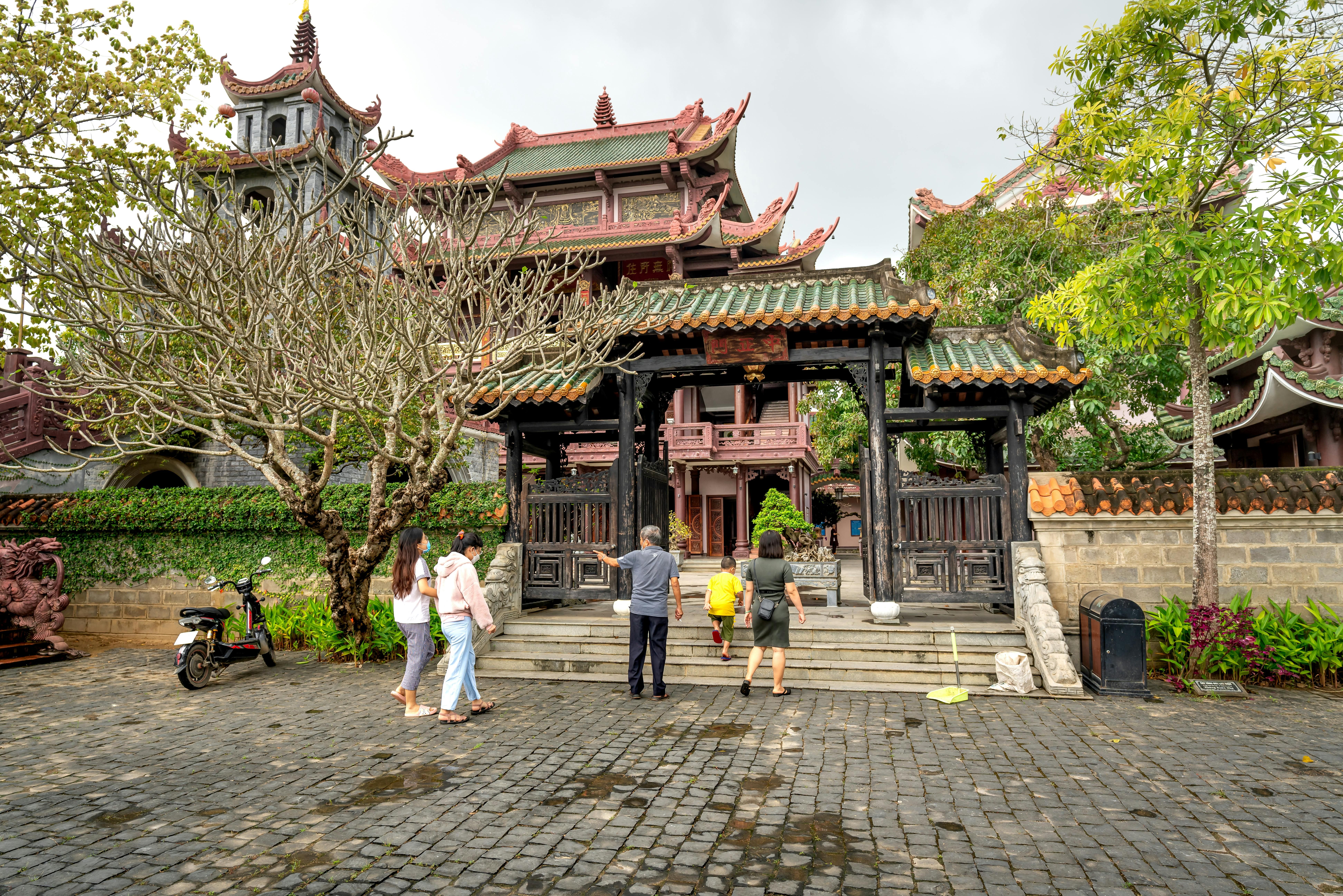 Balinese driver with tourist family temple visit - bali - inline