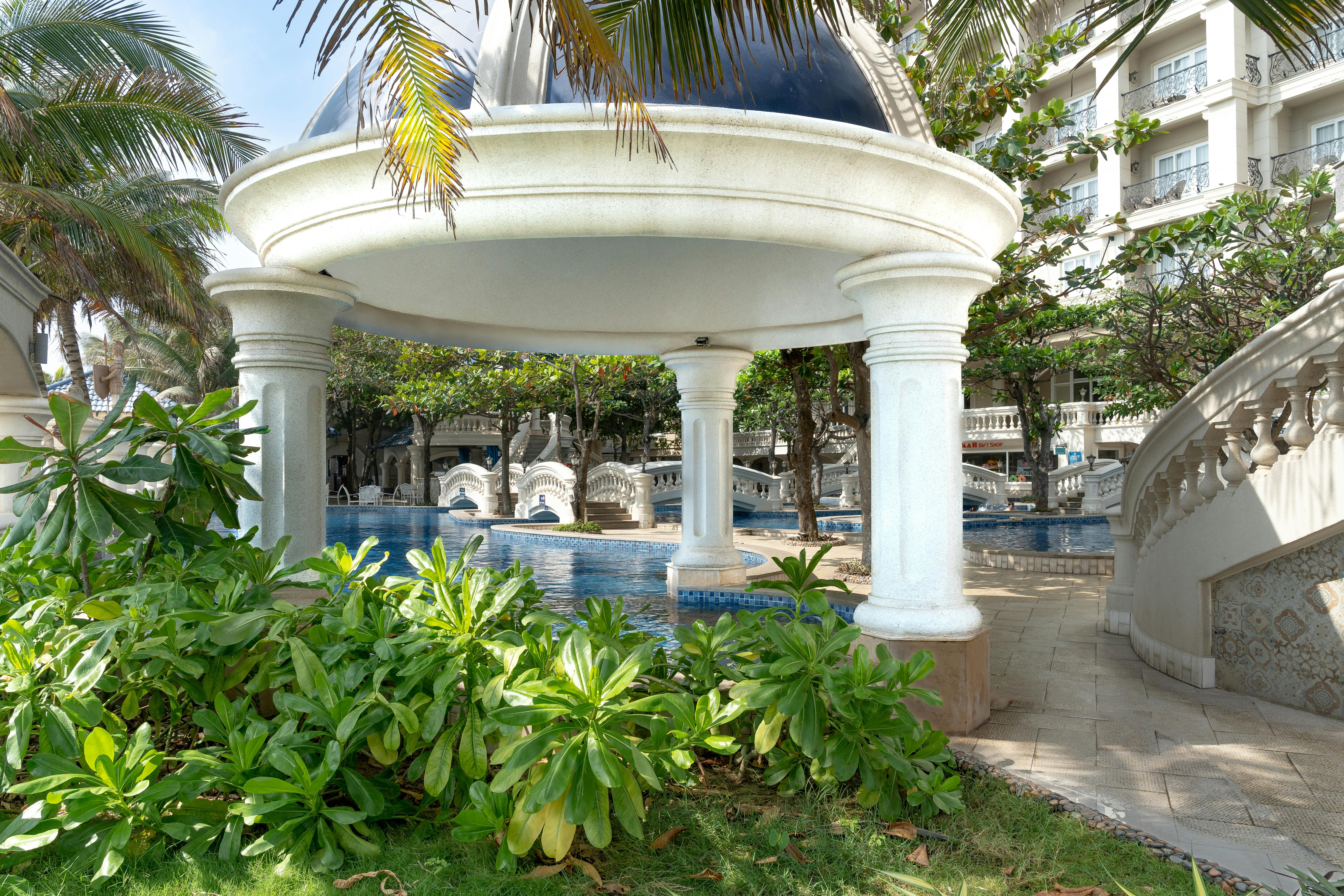 Cambodia — Exquisite luxury resort featuring a domed poolside pavilion amidst tropical greenery.