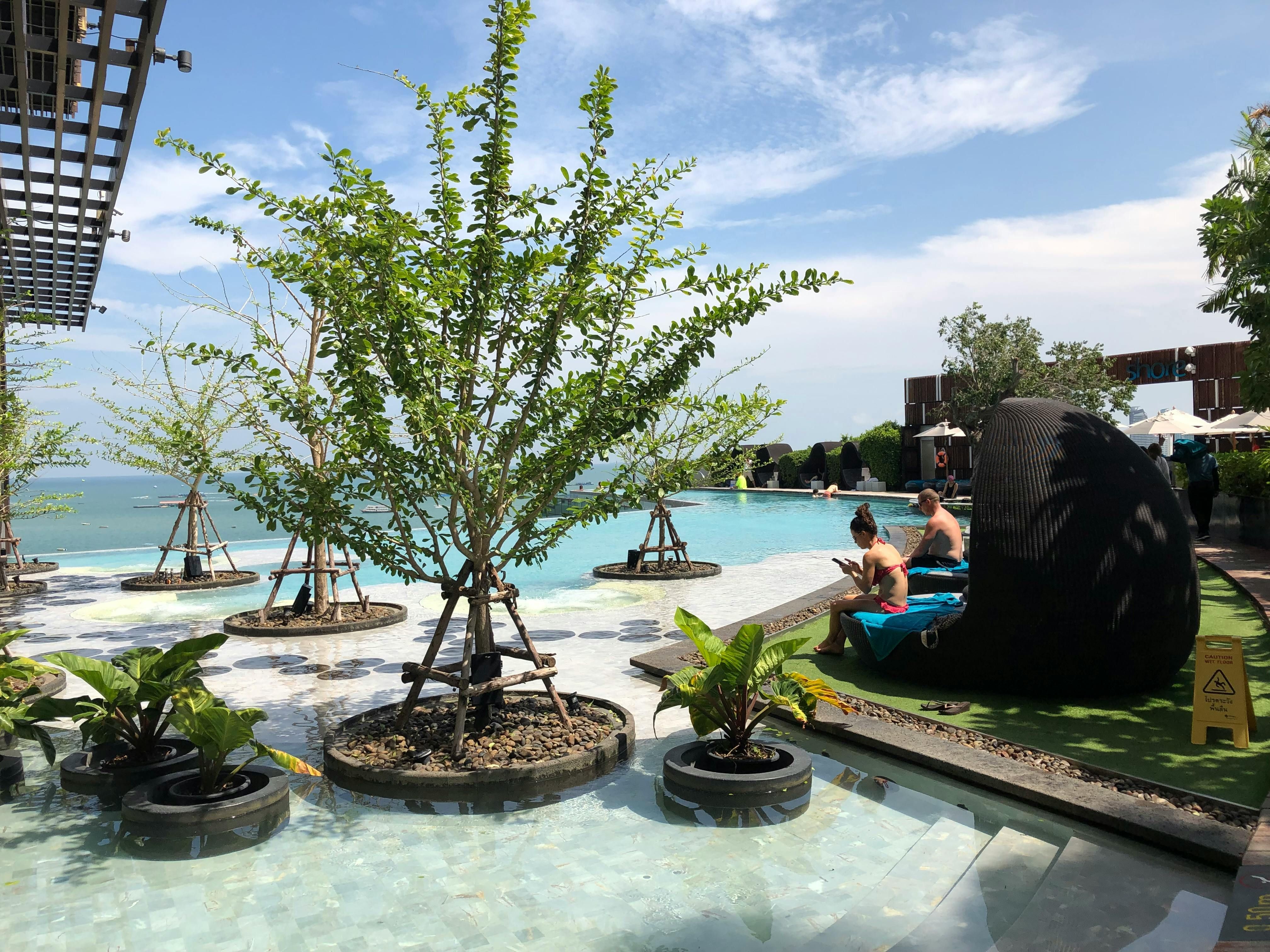 couple relaxing luxury resort pool southeast asia - bali - inline