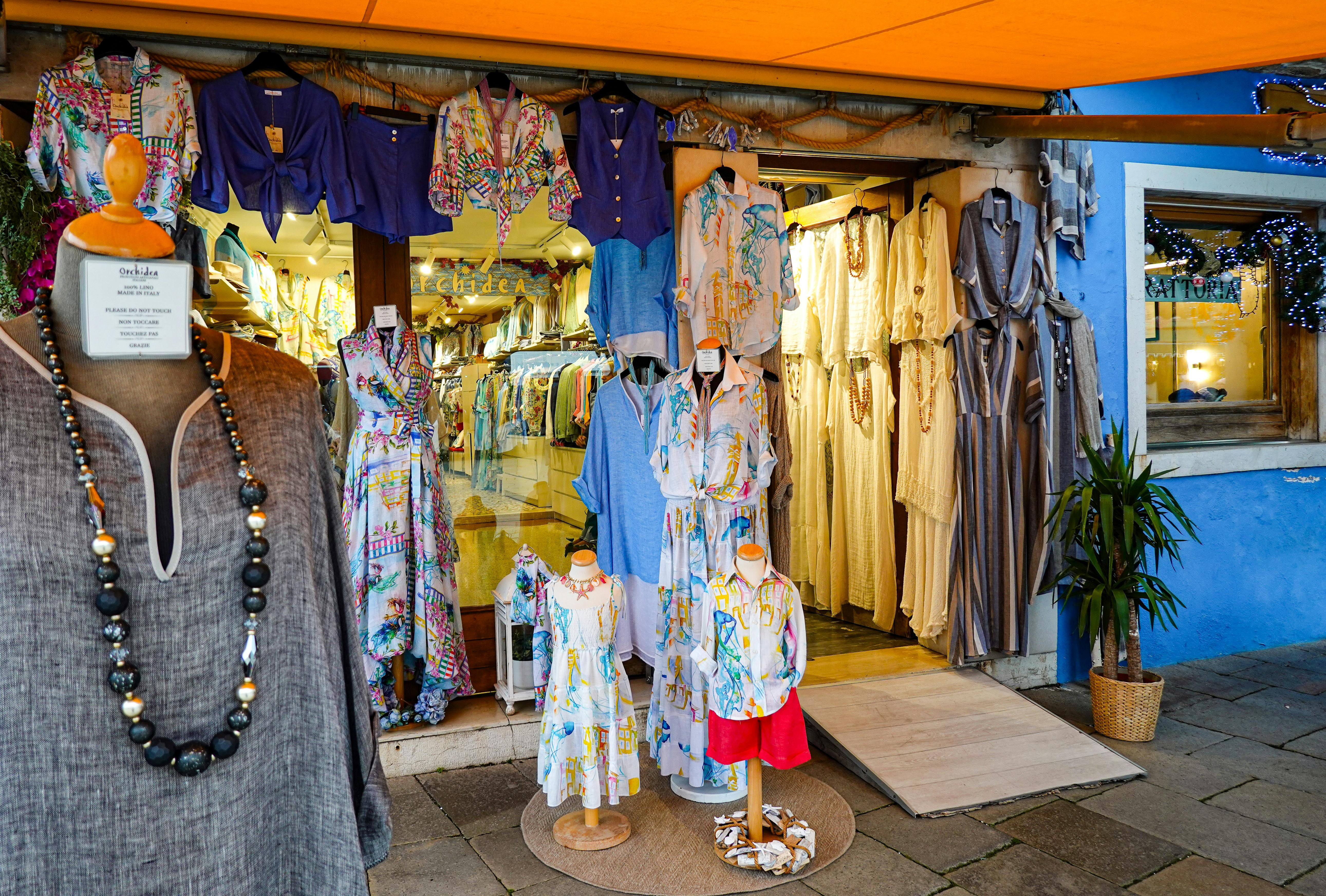 Fiji — Explore a colorful Italian boutique with stylish dresses and vibrant fabrics on display.