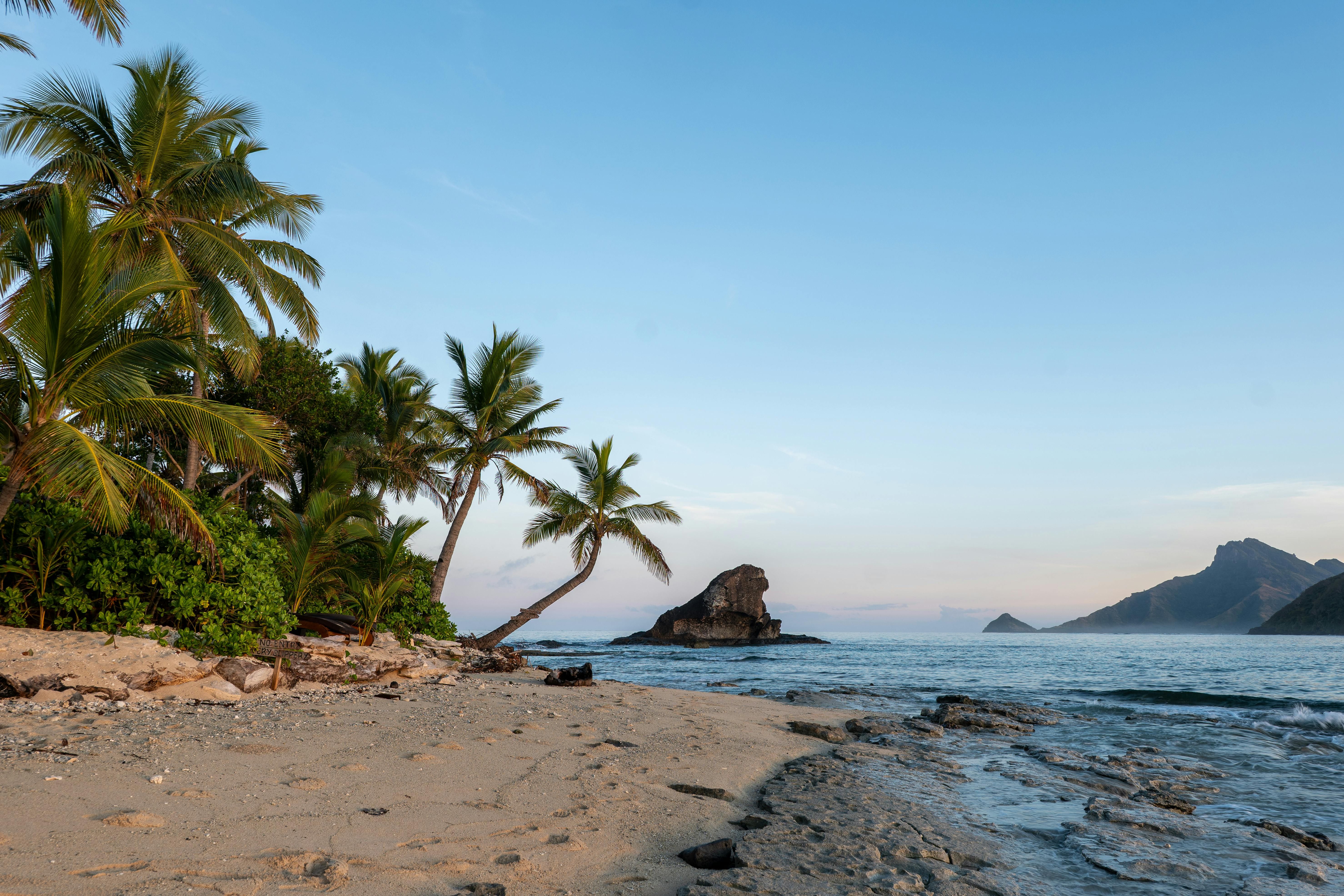 Fiji — Experience the serene beauty of a tropical beach at sunrise on Kuata Island, Fiji.