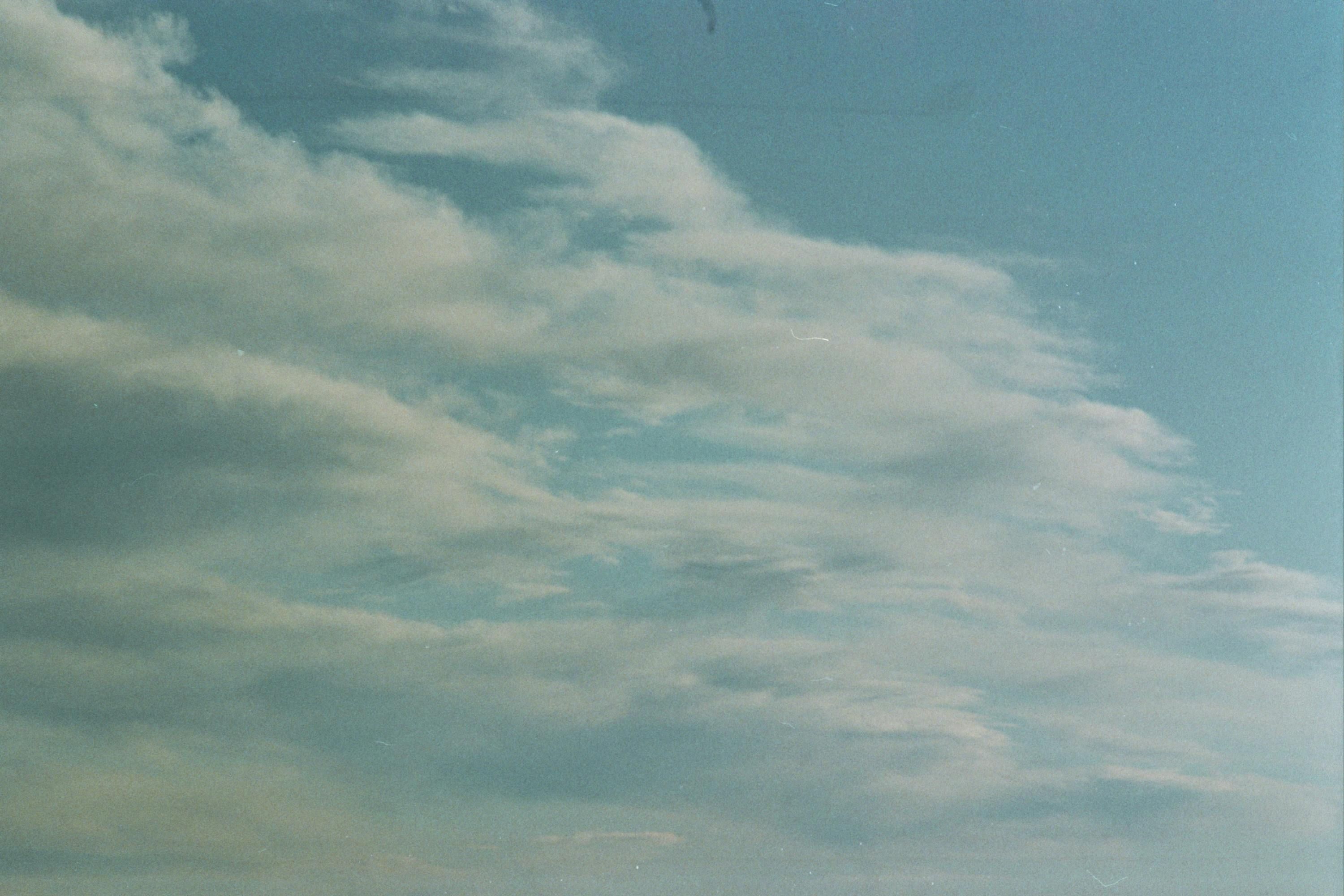 Italy — Tranquil cloudy sky in Lombardy, Italy, showcasing soft clouds against blue sky.