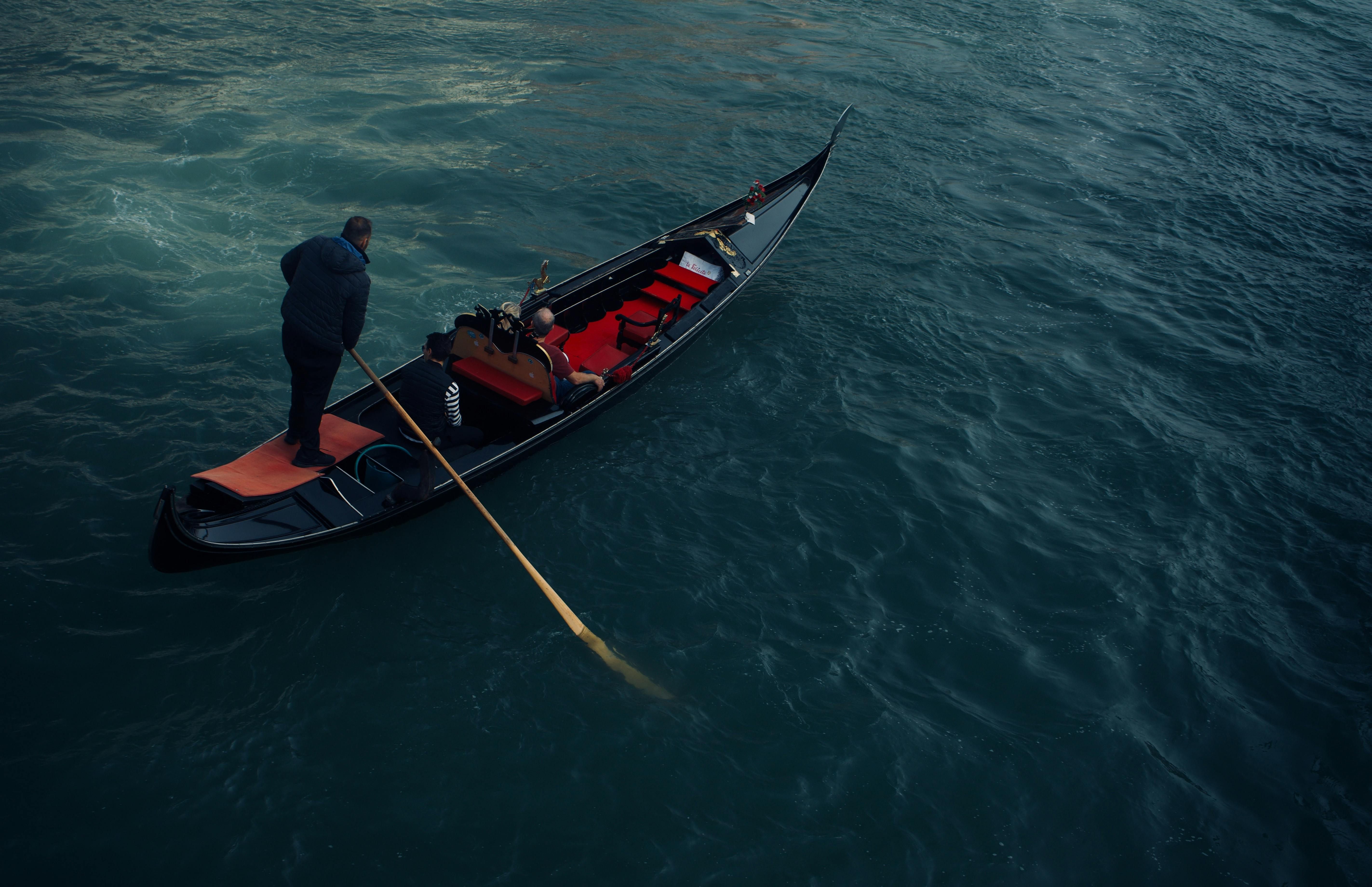 Italy — A gondola navigates peaceful waters, capturing a moment of relaxation and leisure.