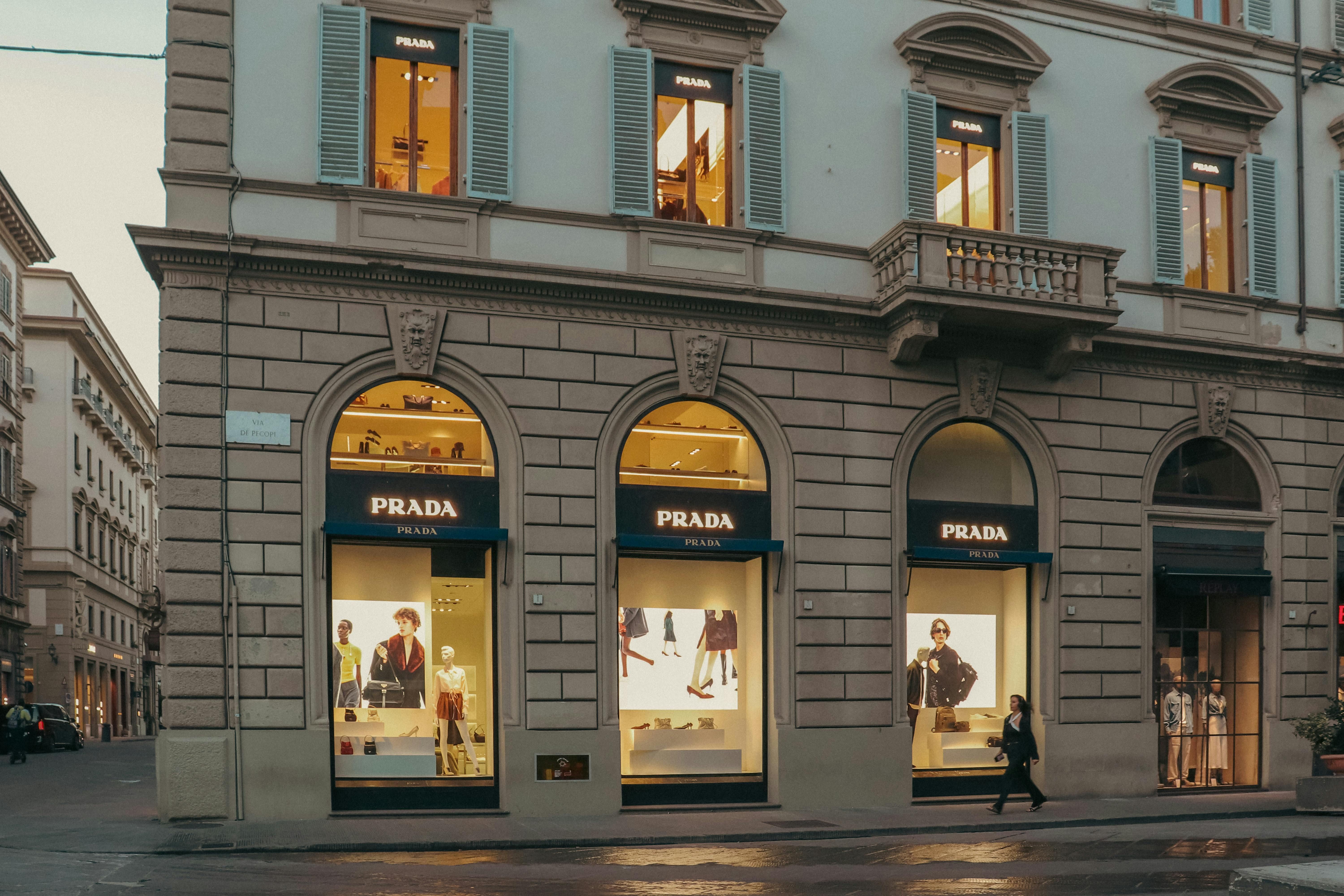 Italy — A stylish view of a Prada store facade in Florence, Italy, during evening hours.
