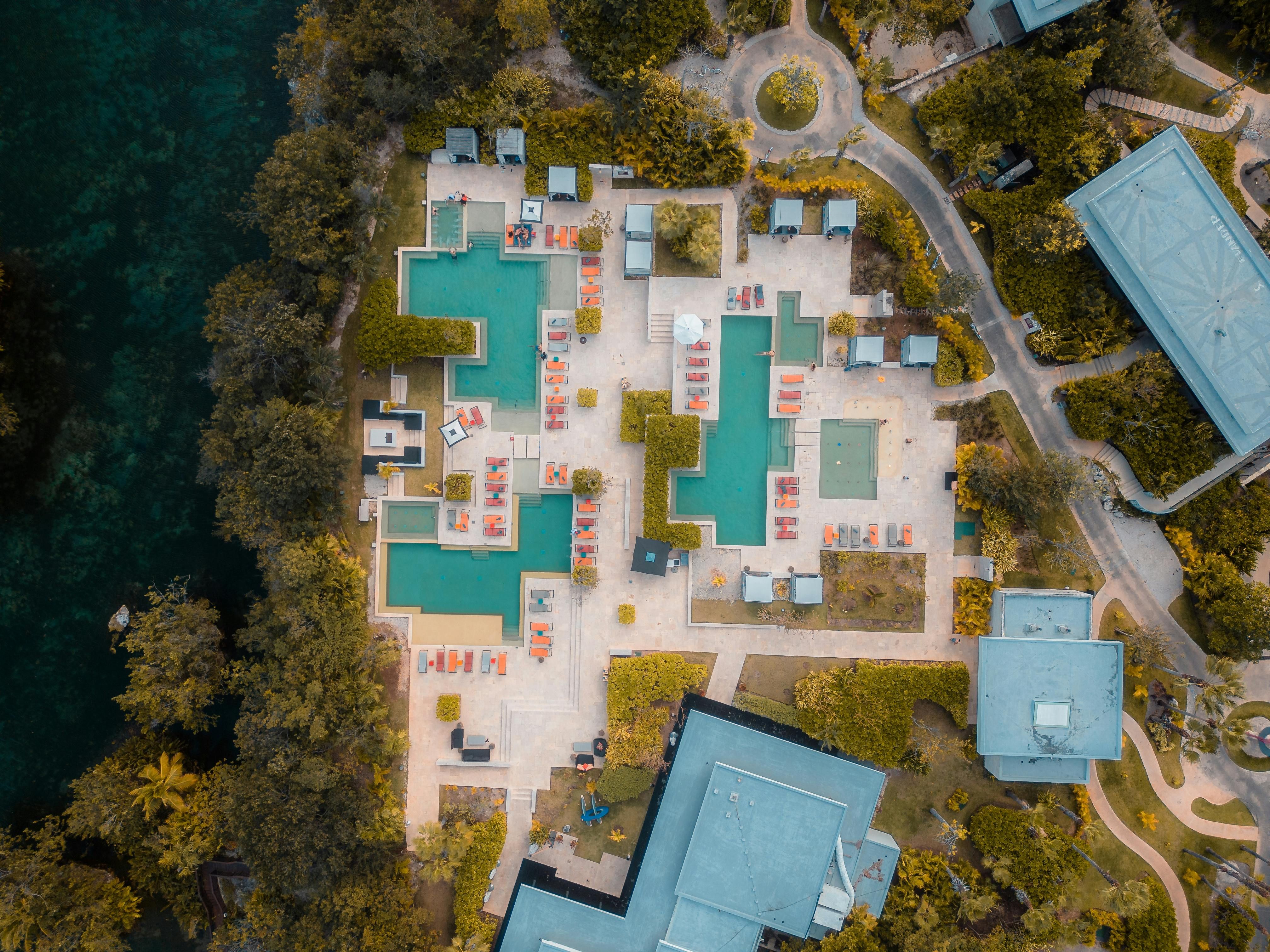 Mexico — Explore the stunning aerial view of a luxury resort in Playa del Carmen, Mexico, showcasing pools and lush greenery.