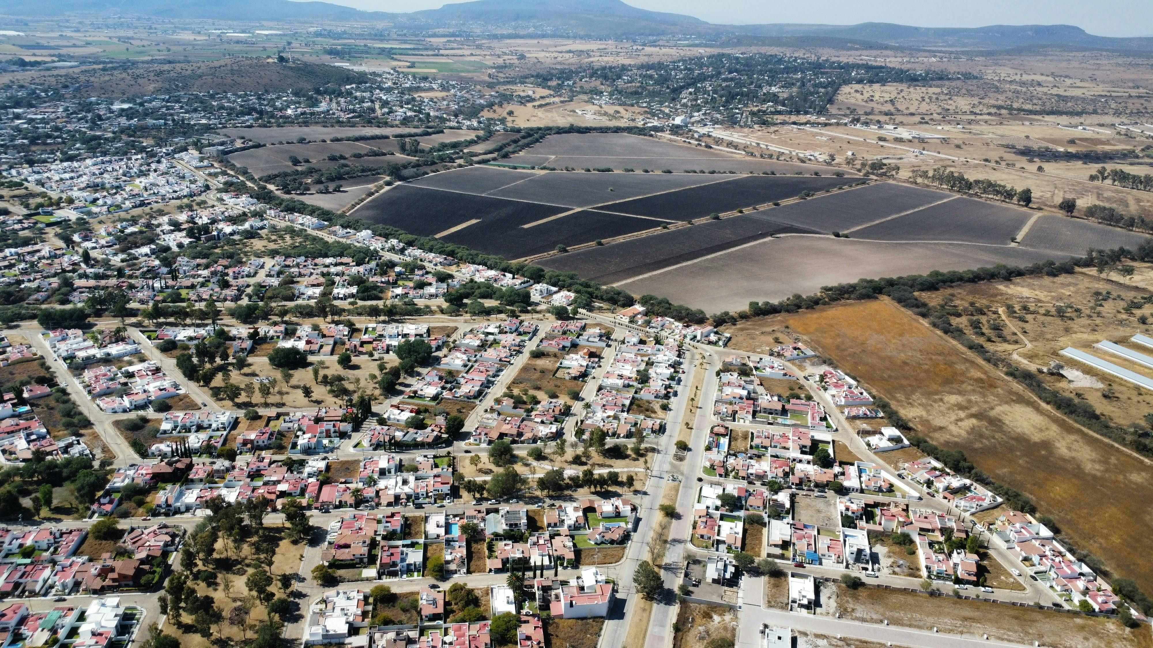 Mexico — Panoramic aerial view of a town and fields in the Mexican countryside on a sunny day.