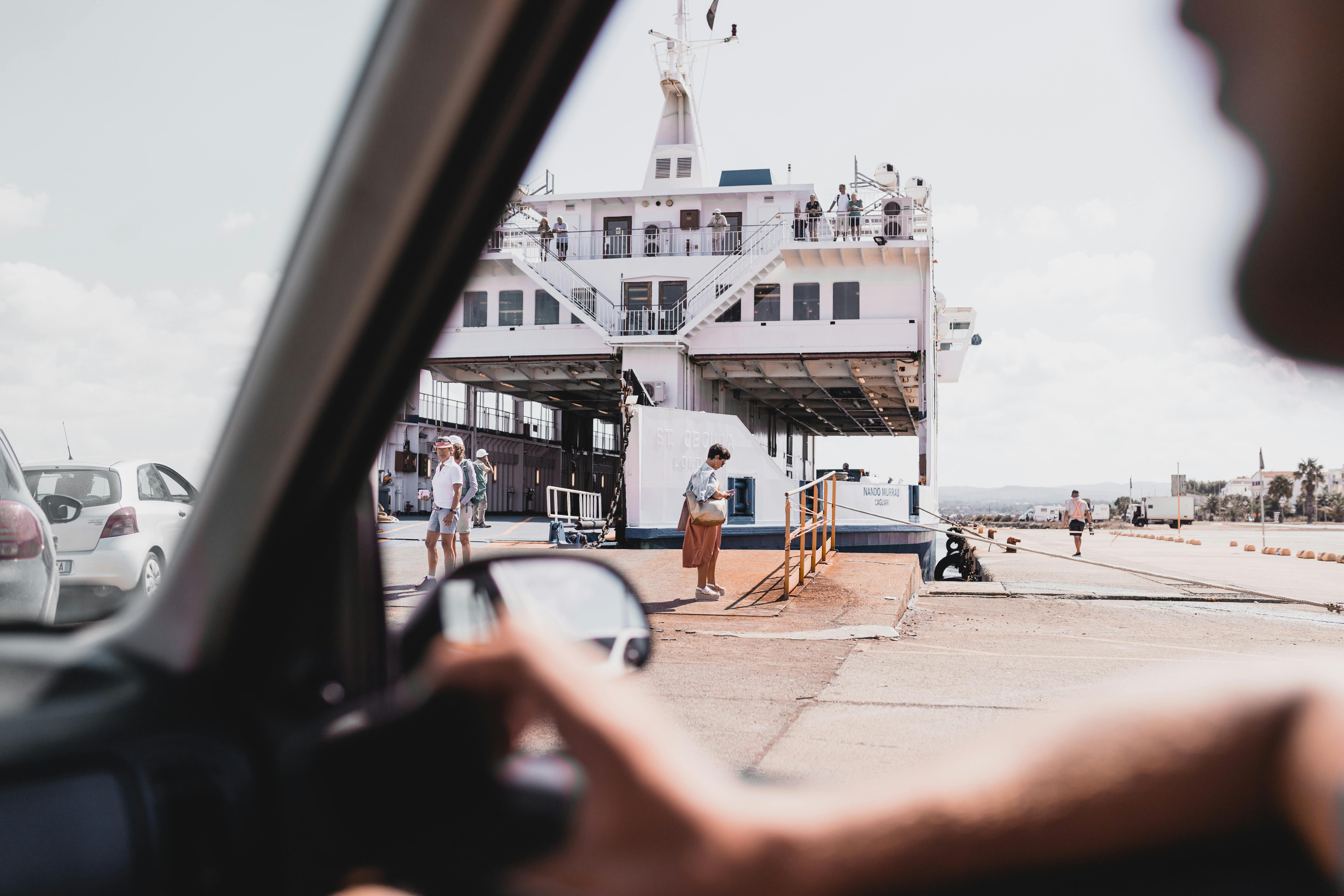 Mexico — Passengers board a ferry at a Sardinia harbor, captured from a car's perspective.