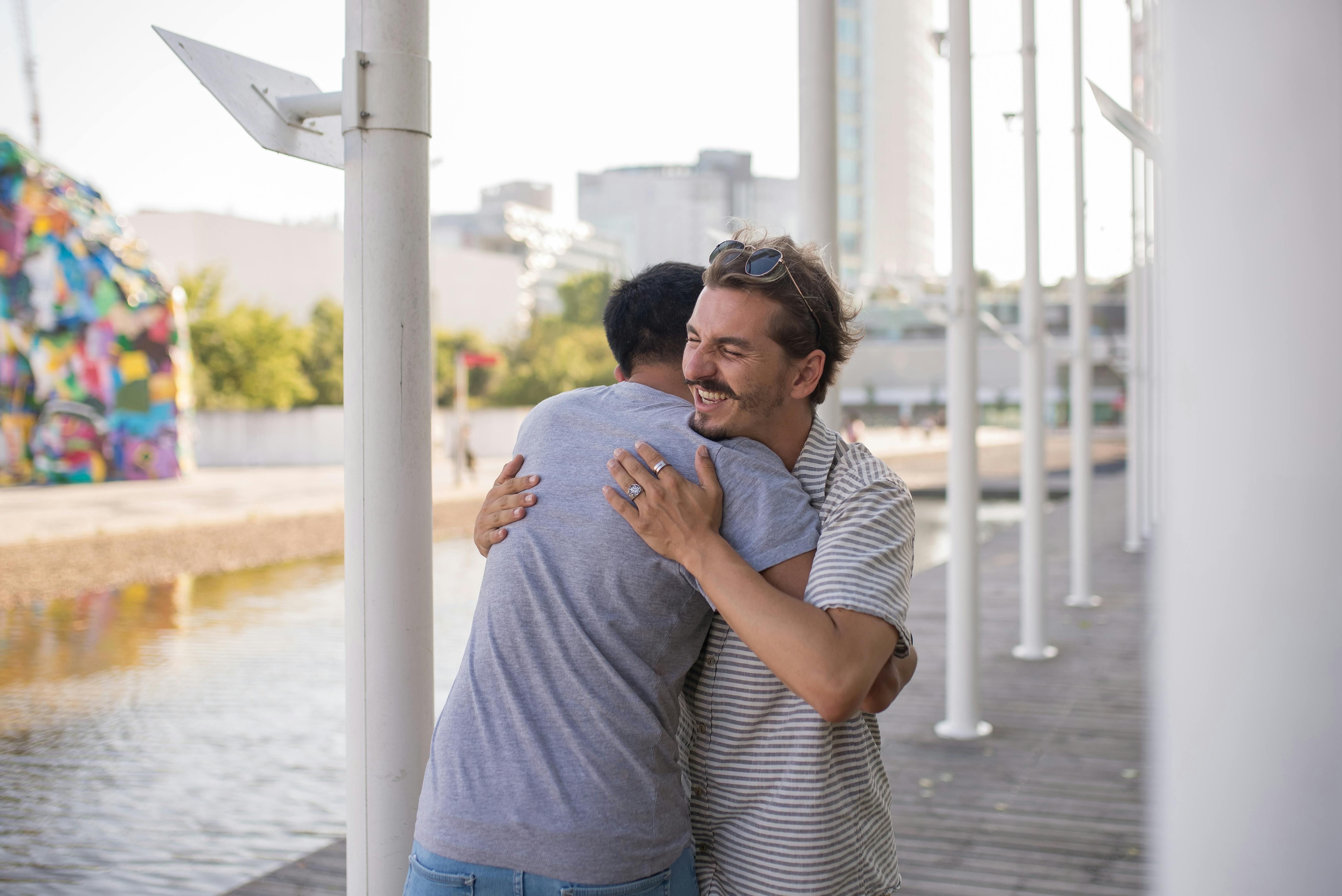 Mexico — Two friends sharing a warm embrace outdoors, showcasing affectionate friendship and happiness.