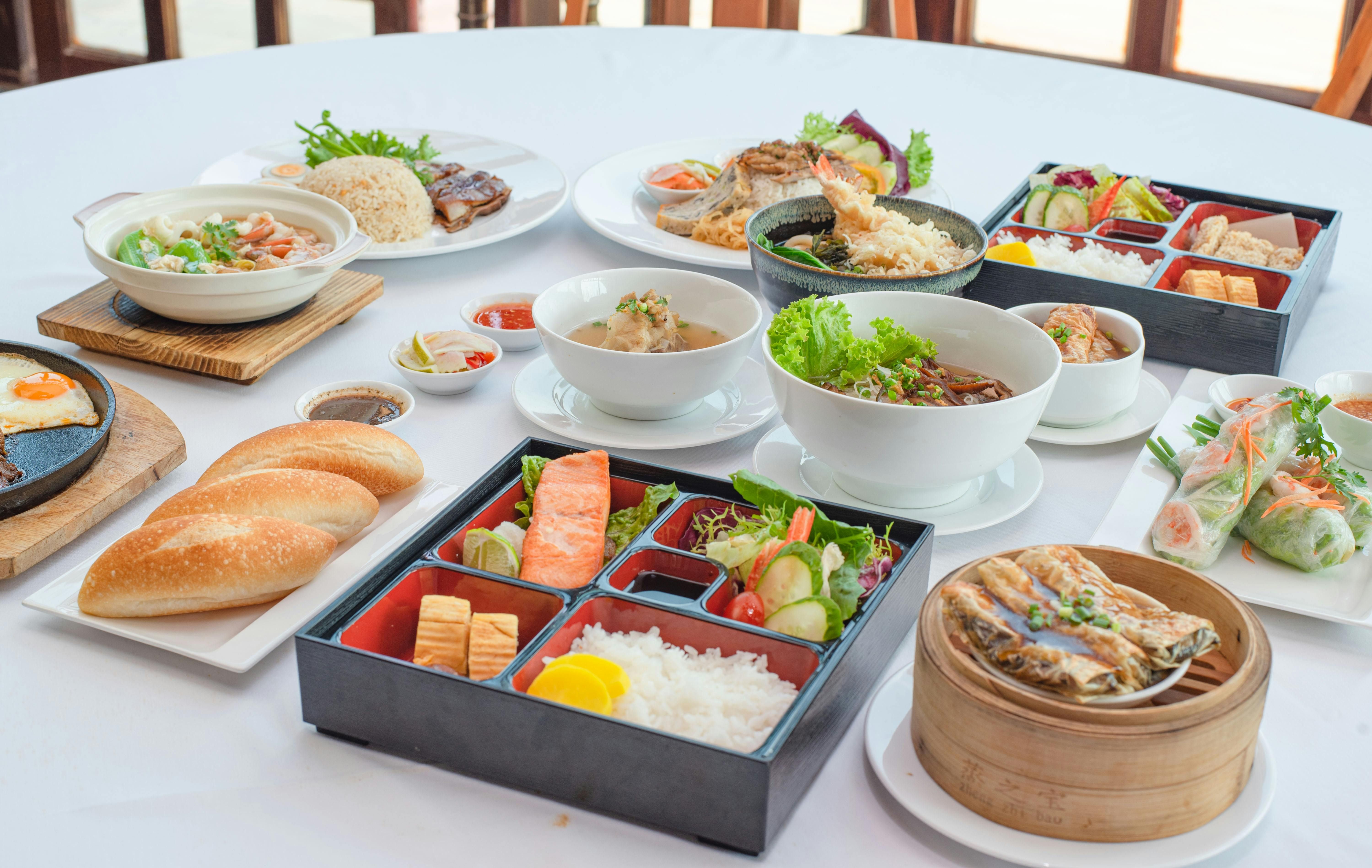 Vietnam — A variety of Asian dishes artistically arranged, showcasing diverse culinary delights for a sumptuous dining experience.