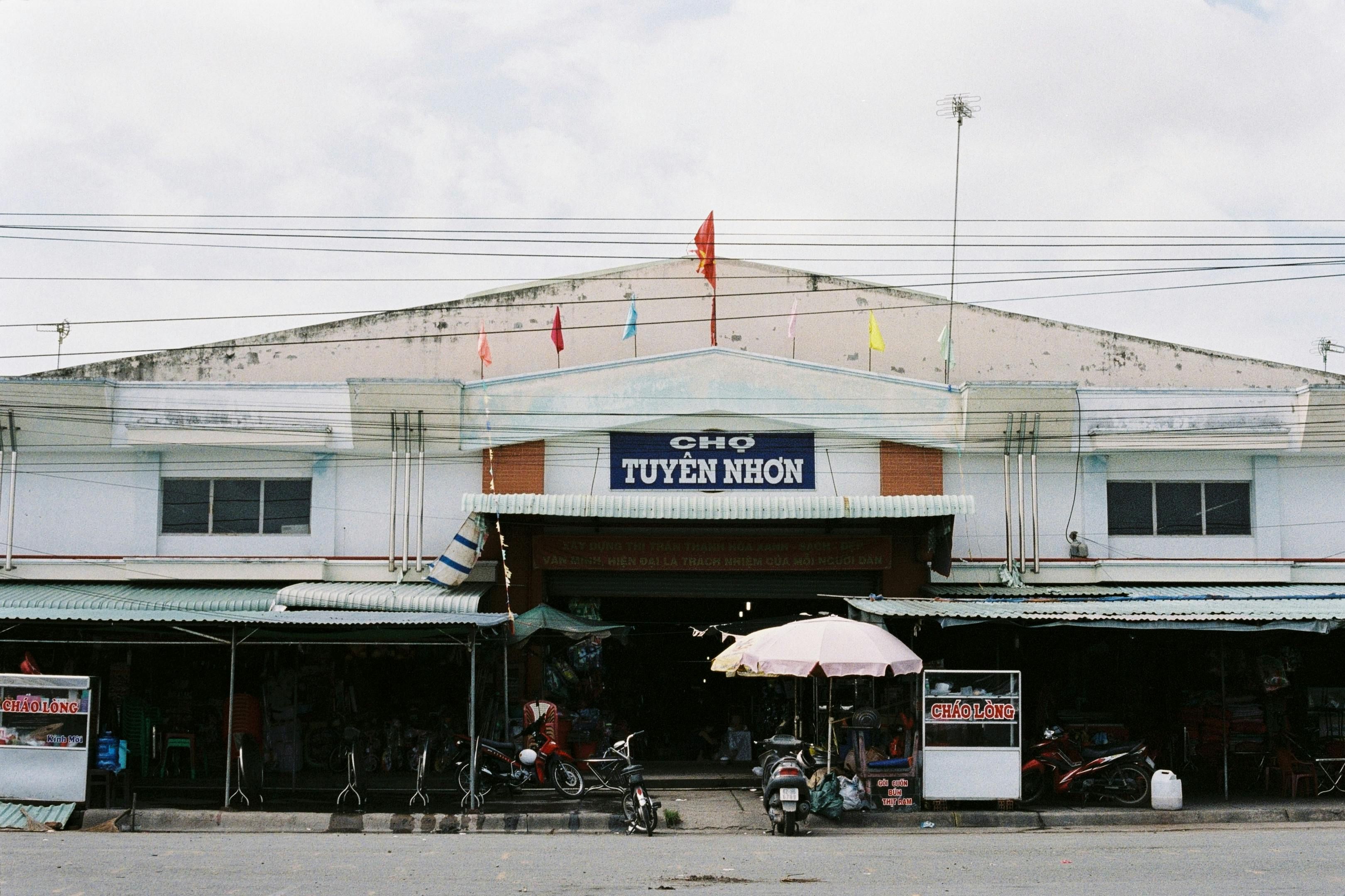 Vietnam — Front view of Tuyen Nhon Market bustling with activity, showcasing Vietnamese street life.
