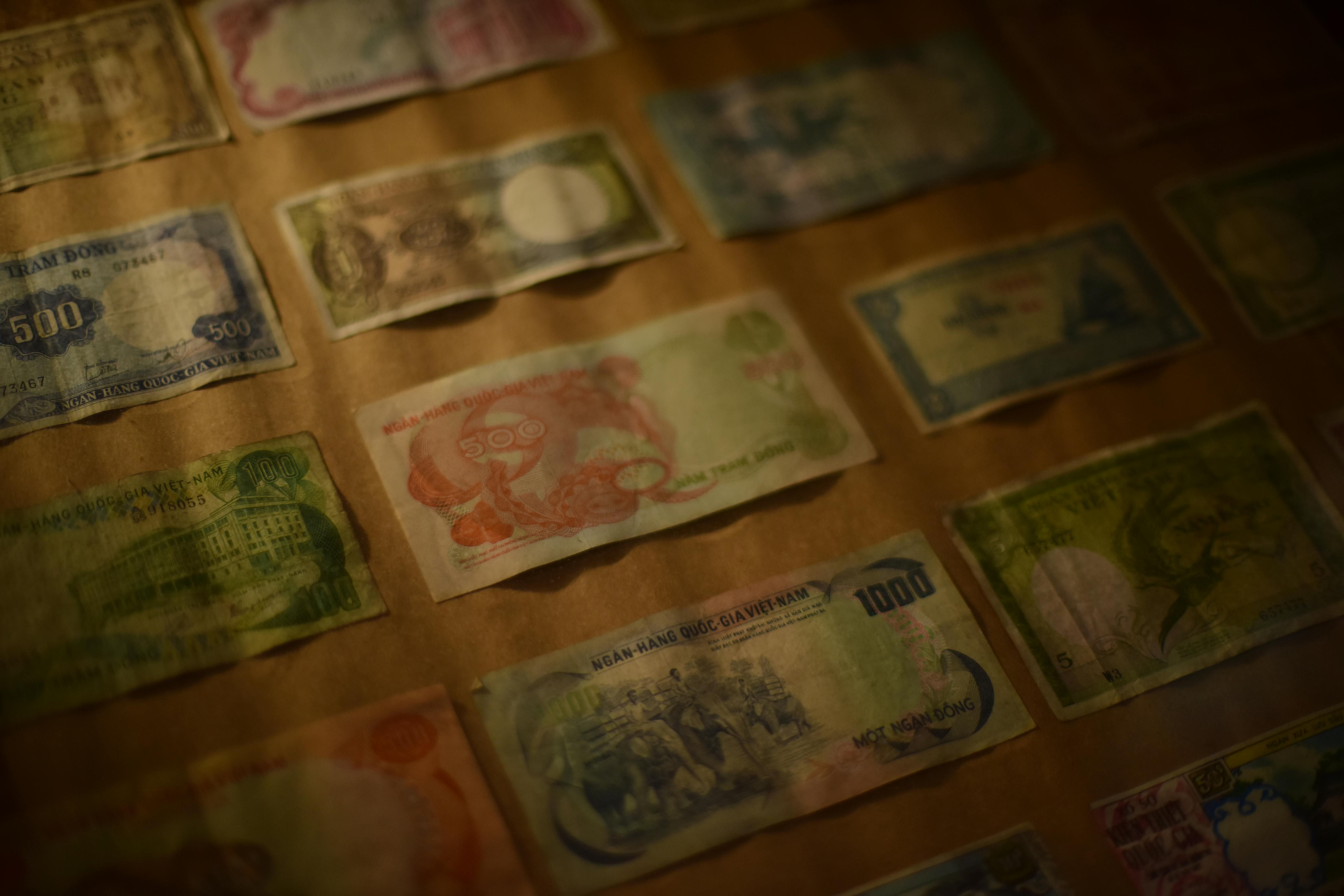 Vietnam — A close-up view of a collection of vintage Vietnamese banknotes displayed under soft lighting.